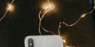 Silver Iphone X Lying on Pre-lit String Lights
