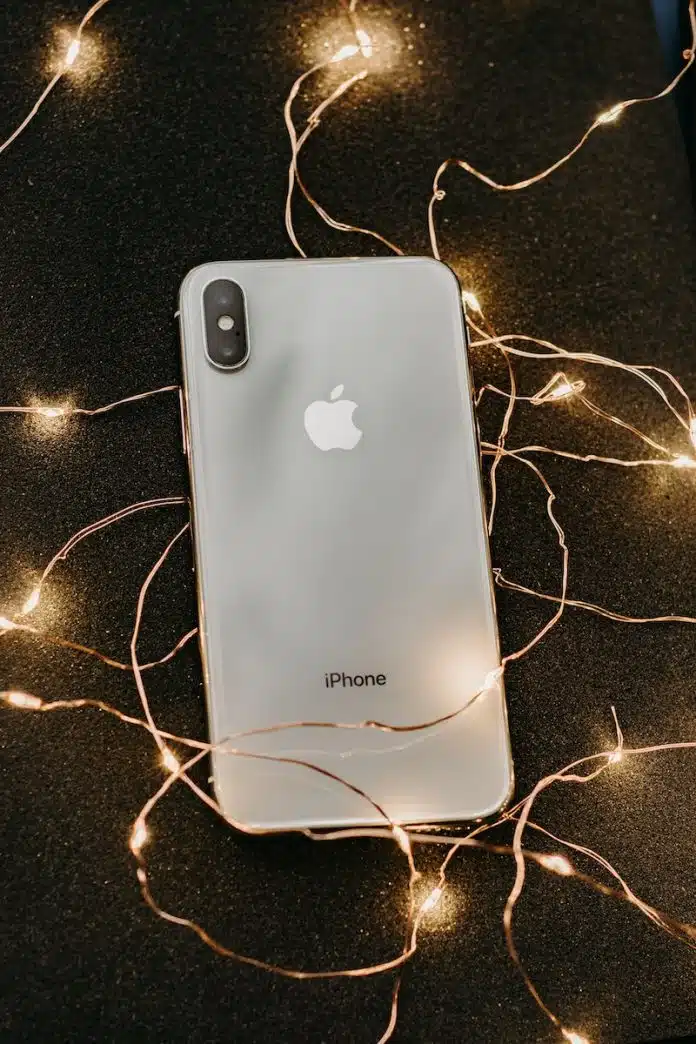 Silver Iphone X Lying on Pre-lit String Lights