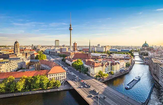 Berlin skyline panorama with TV tower and Spree river at sunset,