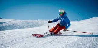 man ice skiing on hill