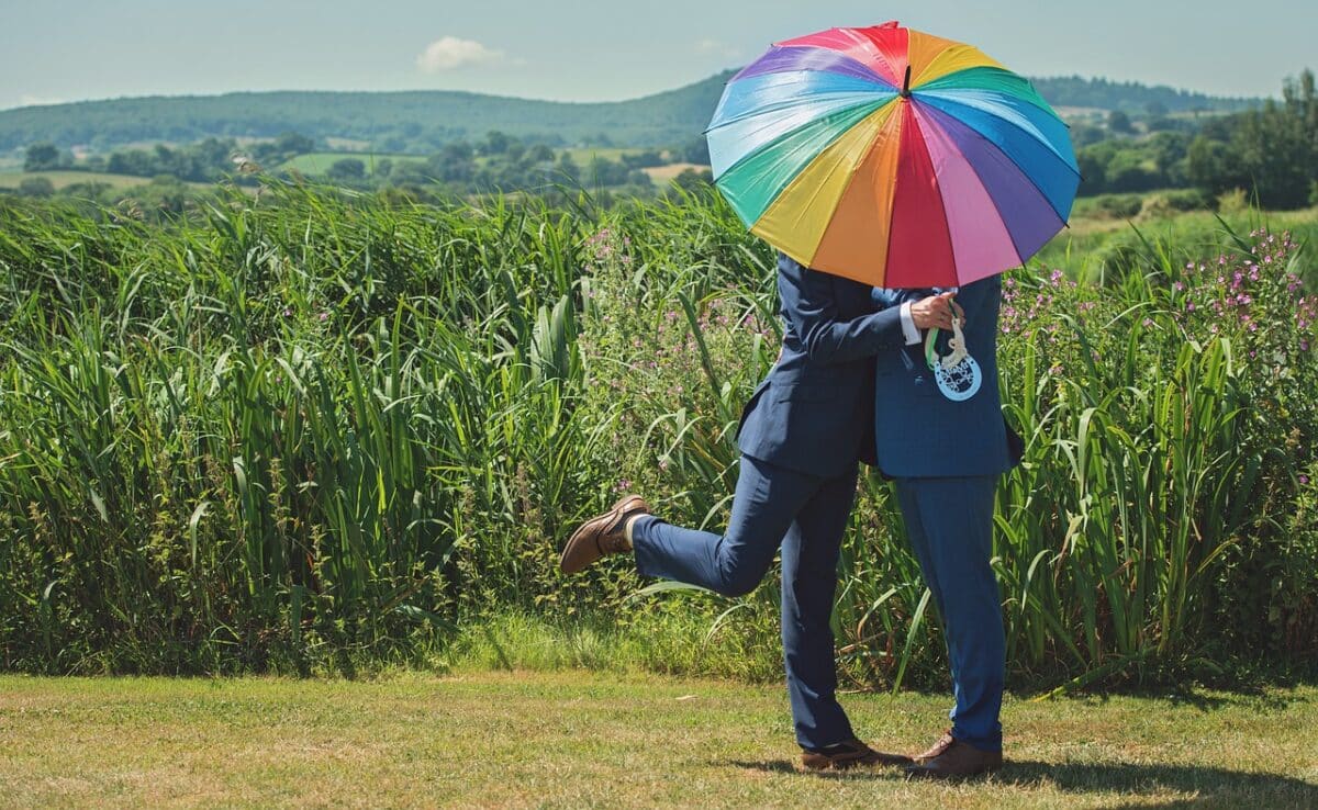 deux mariés sous un parapluie coloré